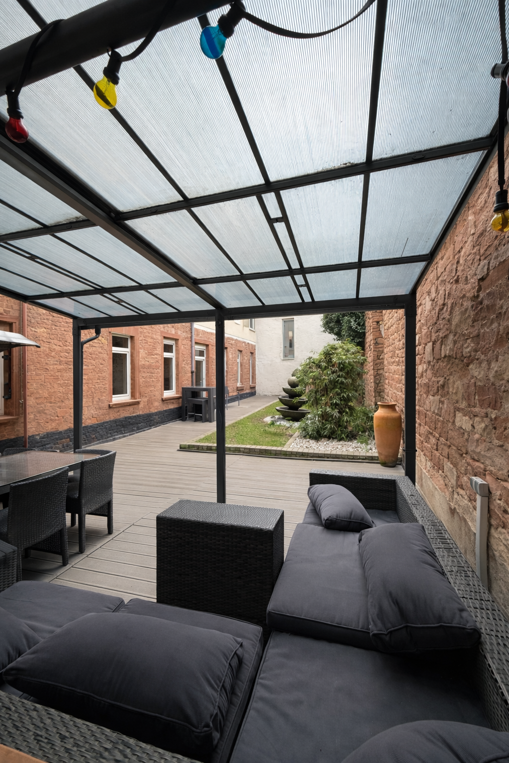 Gemütliche Terrasse unter Pergola im Hof